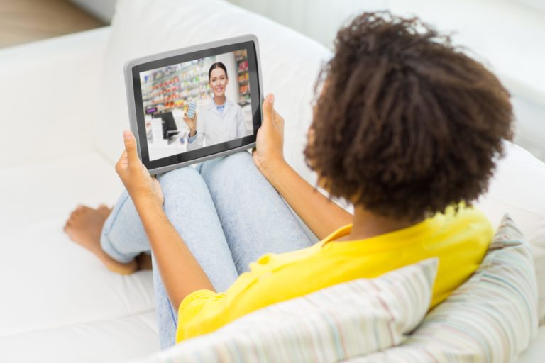 woman having video chat with pharmacist on tablet